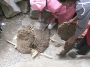 Making Clay Beads – the families are burning the turf to create the clay powder