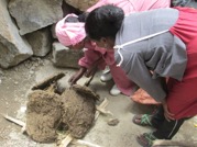 Making Clay Beads – the families are burning the turf to create the clay powder