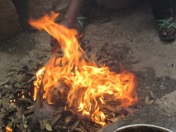 Making Clay Beads – the families are burning the turf to create the clay powder